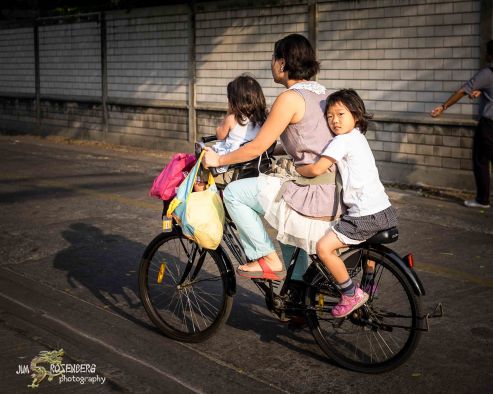 Family riding bike to school.